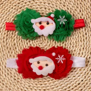 Close-up of baby Christmas headbands with Santa decor and chiffon flowers