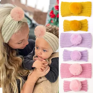 Detail of parent-child knitted headbands with soft pom-poms in various colors