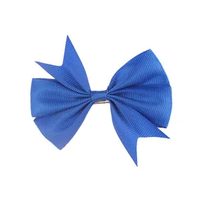 Detail of royal blue grosgrain ribbon bow hair clip with textured tiered layers