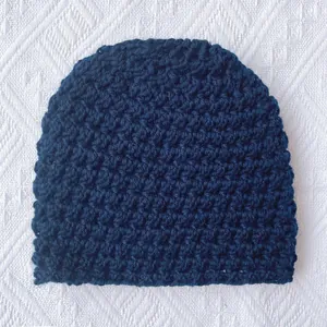Thick navy blue crochet knit winter hat for babies with warm ribbed texture