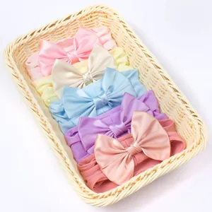 Set van zes zachte elastische nylon baby hoofdbanden met grote strikken in pastelkleuren