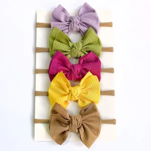 Detailed view of 5-piece infant headband set with ribbed nylon bows in vibrant candy colors