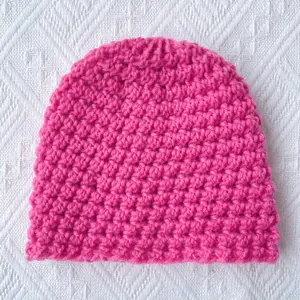 Winter knitted warm baby beanie in hot pink handmade crochet style for boys and girls