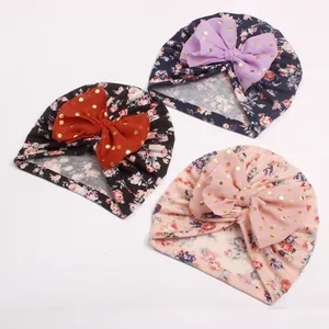 Three-piece infant floral turban hat set with large gold-dotted tulle bows for baby girls