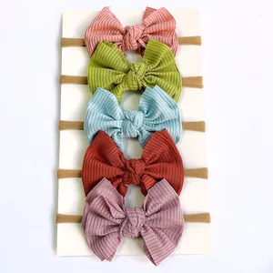 Close-up of 5-pack ribbed fabric baby headbands with soft nylon bands in candy colors