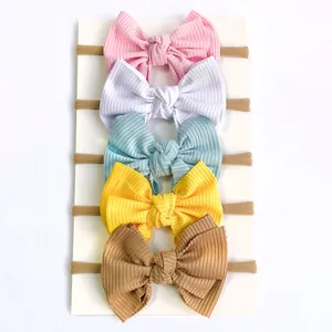 Detailed view of 5-piece baby bow headband set in candy colors with ribbed fabric texture