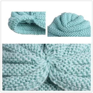 Mint green knitted baby beanie with soft spiral texture and cuffed brim design