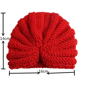 Red knit baby turban hat with sizing measurements of 14cm height and 16cm width