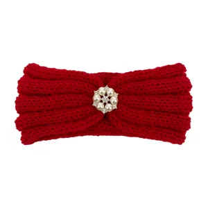 Detailed macro view of red knitted baby headband with six-pearl flower rhinestone center