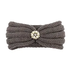 Detail of dark grey knitted baby headband with a cluster of pearls and rhinestones