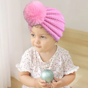 Bonnet en Tricot pour Bébé avec Pompon Turban à Côtes Doux pour Nourrissons et Tout-petits Mignon Chaud Hiver Protection des Oreilles
