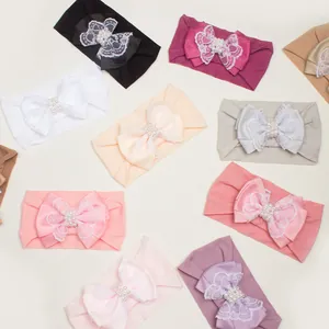 Bandeaux bébé en nylon avec nœuds en dentelle en queue d'aronde et perles nacrées