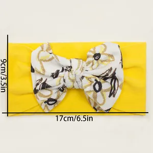 Detailed dimensions of yellow floral bow baby headband showing 17cm width and 9cm height