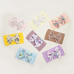 8-pack baby girl floral bow headbands in various pastel colors and soft ribbed fabric