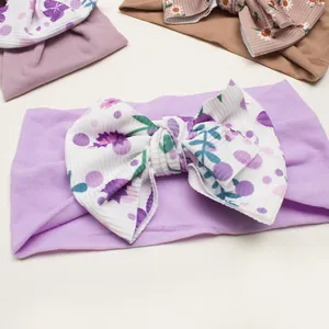 Detail of baby ribbed bow headband featuring purple polka dots and floral prints