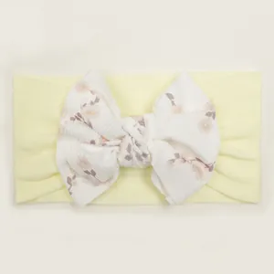 Detail of baby headband featuring yellow ribbed bow with delicate floral print