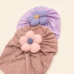 Detail of breathable hollow knit fabric and large 3D flowers on baby beanies