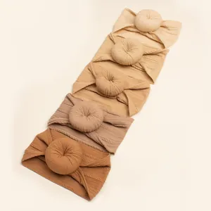 Five-pack of elastic baby headbands with jacquard knit donut knot in warm earthy tones