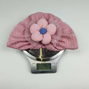 Detailed view of lightweight pink knitted baby hat weighing 42.0g on a scale