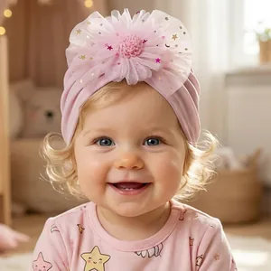 Close-up of pink baby turban hat with mesh flower and gold sequin star moon details