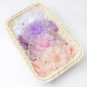 Baby headband set with mesh flowers and sequins in a white wicker basket for summer