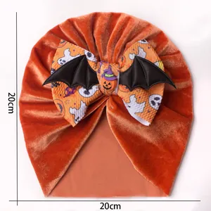 Detail view of 20cm orange velvet Halloween baby turban hat with ghost and pumpkin bow