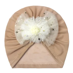Detail of baby turban mesh flower with gold sequin stars and moon decorations