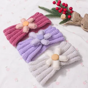 Three colors of cute knit baby headbands with large fabric flowers for autumn winter