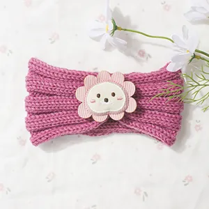 Detail of baby knitted headband in purple with a cute cartoon lion patch for winter warmth