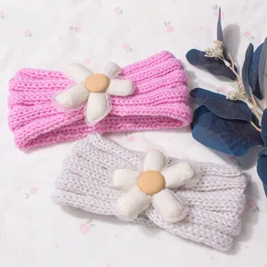 Detailed close-up of knitted baby headband with decorative 3D floral petals and soft mesh