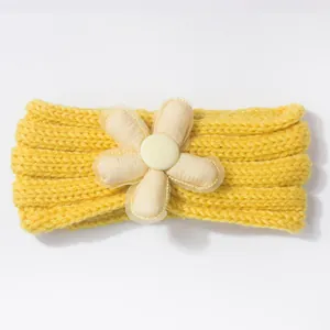 Charming yellow knit baby headband featuring a delicate soft fabric flower and mesh detail