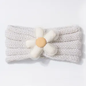 Close-up of cream knit baby headband with large white daisy flower and mesh detail