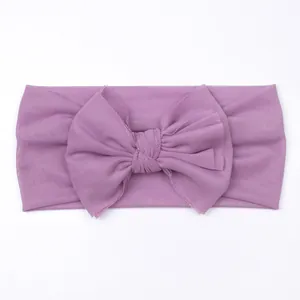 Soft purple mesh baby headband featuring a large bow and elastic nylon fabric for infants