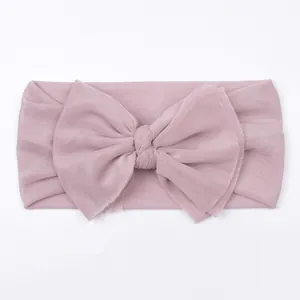 Detail of baby soft mesh headband with large double bow in dusty rose pink color