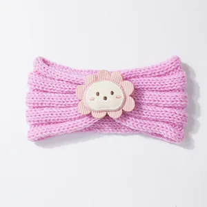 Close-up of pink knitted baby headband with a cute flower animal patch detail