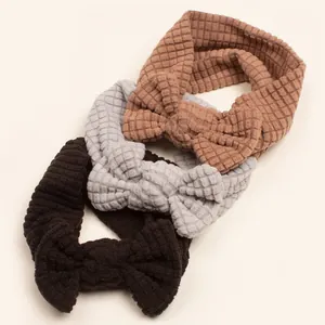 Three waffle texture baby headbands with bows in brown, grey, and coffee colors