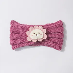 Detailed knit texture of rose pink baby headband featuring a cute lion mascot patch
