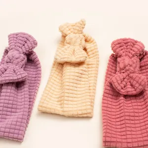 Detailed waffle texture and oversized bow on soft purple, yellow and red baby headbands