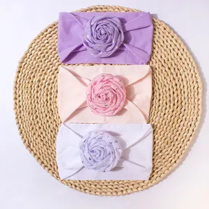 Three-pack of elastic nylon baby headbands with large glitter rose flower ornaments