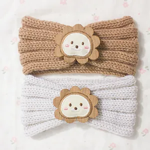 Cute knitted baby headbands in brown and beige featuring cartoon lion and bear patches