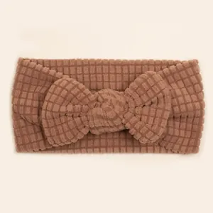 Close-up of caramel waffle texture knit baby headband with a large decorative bow