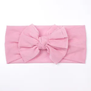 Close-up of soft pink mesh baby headband featuring a large layered mesh bow detail
