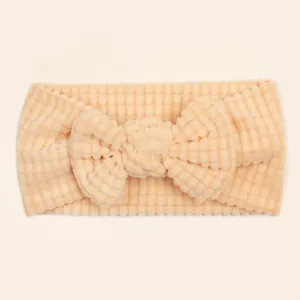 Detail of soft waffle knit texture on baby headband with cute bow decoration
