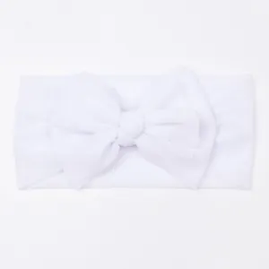 Detail view of the soft white mesh fabric and oversized bow on the infant headband