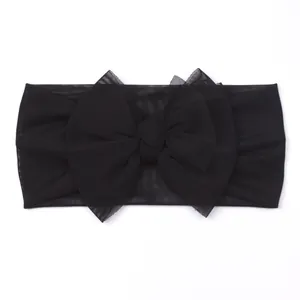 Soft black mesh infant headband featuring a large layered tulle bow for newborns