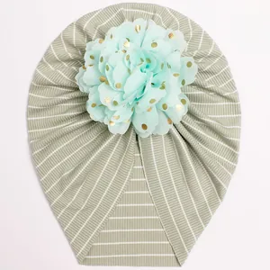 Detail of baby striped turban hat with a large mint green flower and gold foil dots