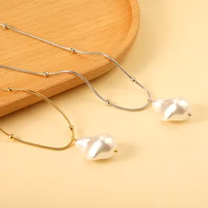 Baroque irregular pearl pendant necklace with gold and silver snake chain links
