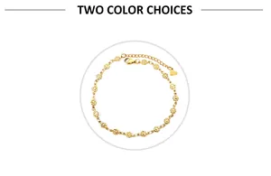 Detailed view of gold flower links and heart charm on stainless steel anklet chain