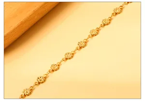 Close-up of elegant gold flower link anklet showing intricate metal texture and shine