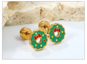 Detailed macro view of Christmas wreath stud earrings with red bows and screw-back closure
